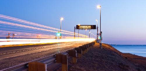 Cars and Trucks head onto the longest bridge over ice covered waters, The Confederation Bridge