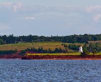 Fort Amherst sits in the distance as the lighthouse lights up.